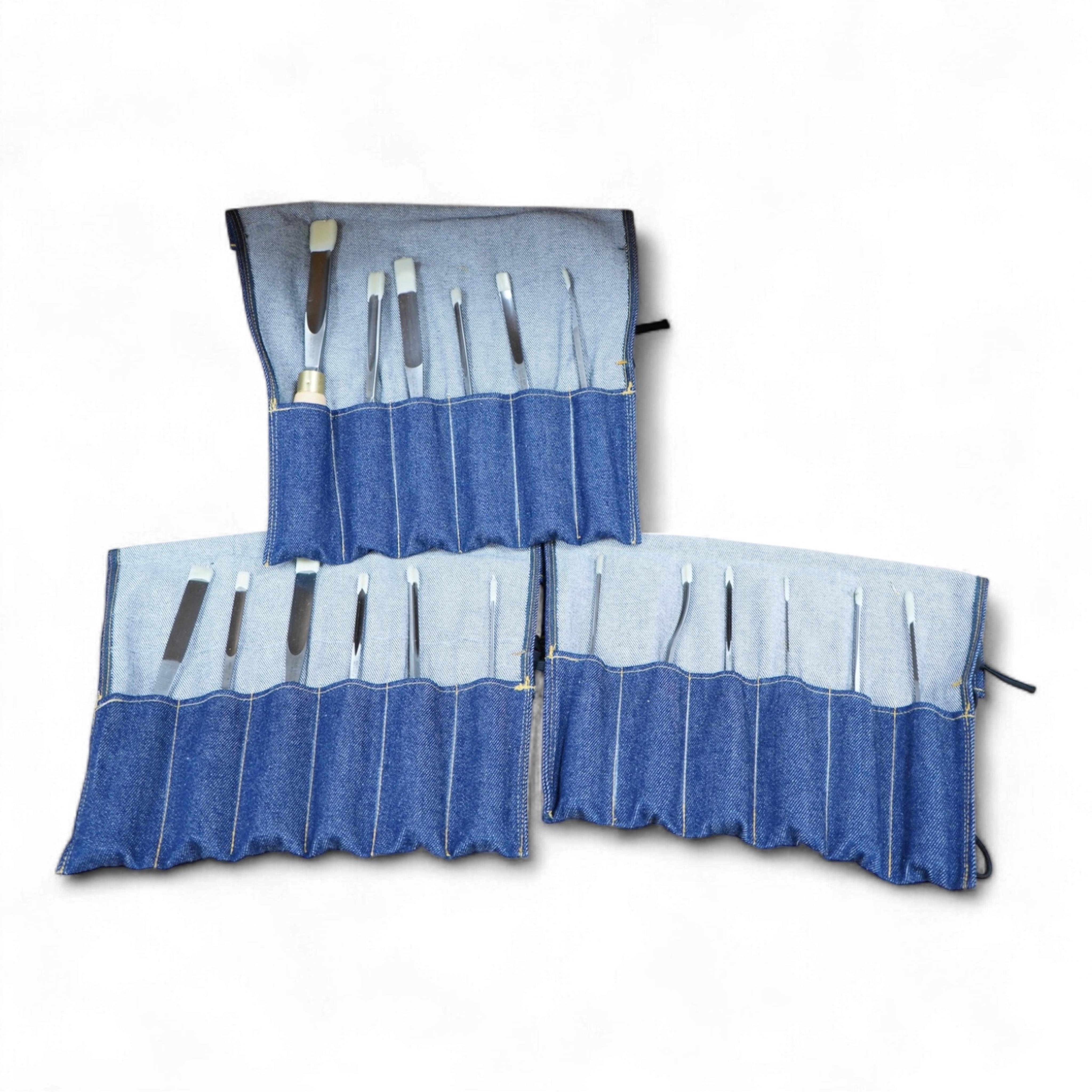 Three sets of Ashley Iles wood carving tools, contained within denim tool rolls; the York Set, the Supplementary Set No.Two, and the Supplementary Set No.Three, each comprising of six chisels (18 chisels in total)